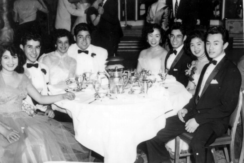 Students sitting at table dressed up at senior prom